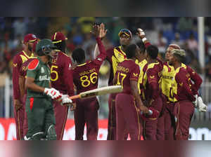 Sharjah : West Indies players celebrate the dismissal of Bangladesh's Liton Das ...