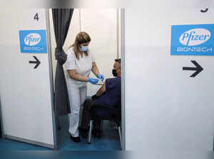 A healthcare worker administers a dose of Pfizer's coronavirus disease (COVID-19) vaccine to a man at Belgrade Fair vaccination center in Belgrade