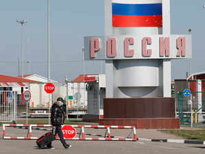 FILE PHOTO: A man walks at a crossing point on the border with Russia in Hoptivka