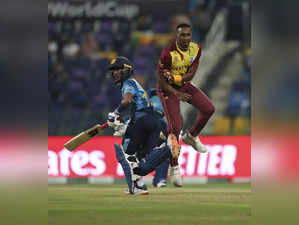 Abu Dhabi : West Indies' Dwayne Bravo collides with Sri Lanka's Pathum Nissanka ...