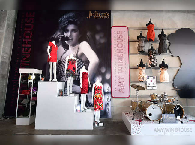 A collection of Amy Winehouse dresses and her drum set are displayed at Julien's Auctions in Beverly Hills, California​