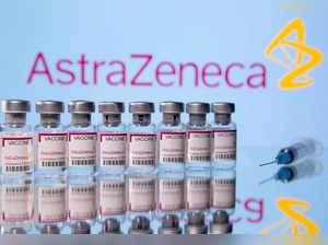 Vials labelled "Astra Zeneca COVID-19 Coronavirus Vaccine"nd a syringe are seen in front of a displayed AstraZeneca logo in this illustration photo