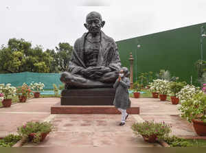 New Delhi: Lok Sabha Speaker Om Birla gestures in front of Mahatma Gandhi statue...