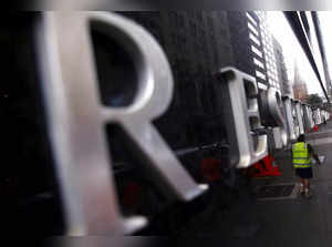 FILE PHOTO: A worker is reflected in a wall of the Reserve Bank of Australia head office in central Sydney, Australia