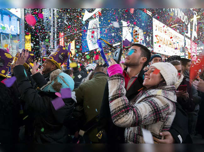 FIle photo of Jan. 1, 2017​: Confetti falls as people celebrate the new year in New York's Times Square.