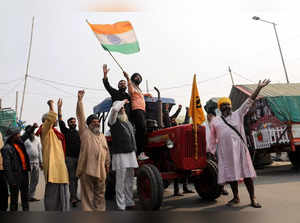 Farmers celebrate after Indian PM Modi announced that he will repeal the controversial farm laws, near Delhi-UP border