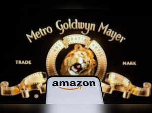 Smartphone with Amazon logo is seen in front of displayed MGM logo in this illustration taken