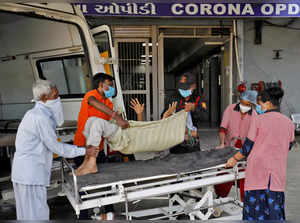 Jagdishbhai Himmatbhai Solanki, with a breathing problem, is wheeled inside a COVID-19 hospital for treatment in Ahmedabad