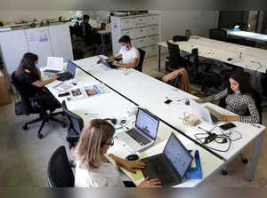 Leo Burnett advertising agency staff work on their desks in Beirut