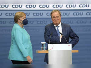 Berlin: Chancellor Angela Merkel stands next to Governor Armin Laschet, right, t...