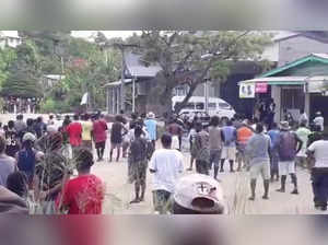 People gather near Naha Police station as Solomon Islanders defied a government-imposed lockdown and protested in Honiara