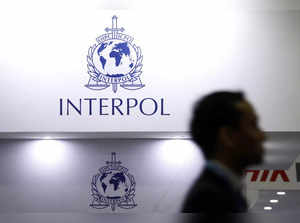 A man passes Interpol signages at Interpol World in Singapore