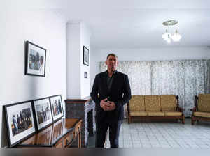 FILE PHOTO: Former Australian cricket player Shane Warne stands in the house that Nelson Mandela occupied at Drakenstein Prison, near Cape Town