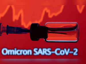 FILE PHOTO: A vial and a syringe are seen in front of a displayed stock graph and words "Omicron SARS-CoV-2" in this illustration taken