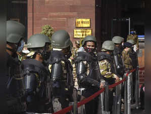 New Delhi: Security personnel stand guard as TMC MPs stage a sit-in protest outs...