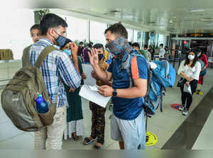 **EDS, RPT CORRECTS BYLINE** New Delhi: Air travellers stand in a queue for COVI...