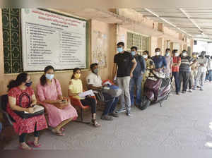 Students studying abroad wait for their turn to get vaccinated agains...
