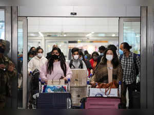 People exit from the arrival section of the Indira Gandhi International Airport in New Delhi