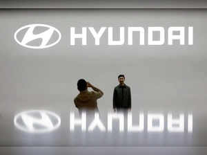 FILE PHOTO: Visitors take photographs in front of the logo of Hyundai Motor during the 2019 Seoul Motor Show