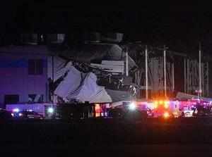 Emergency vehicles surround the site of an Amazon distribution warehouse with a collapsed roof in Edwardsville