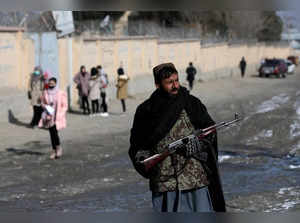 A Taliban fighter guards a street in Kabul