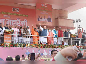 Lucknow:  Union Home Minister Amit Shah waves at the crowd during the BJP-Nishad...