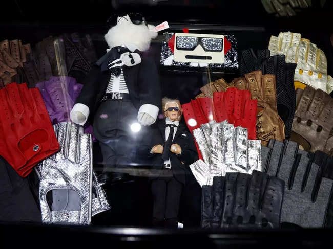 ​Pairs of gloves and a doll depecting late fashion designer Karl Lagerfeld are displayed.