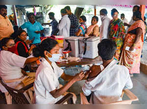 health worker administers a dose of COVID-19 vaccine