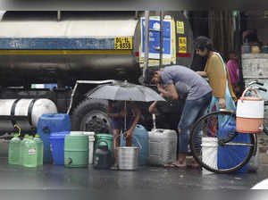 New Delhi: Residents collect drinking water from a tanker at Kailash Nagar in Ne...