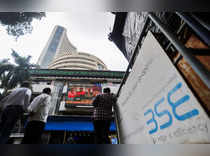 FILE PHOTO: People stand outside the Bombay Stock Exchange (BSE), after Sensex surpassed the 60,000 level for the first time, in Mumbai