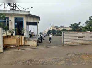 Security guards stand at the entrance of a closed plant of Foxconn India
