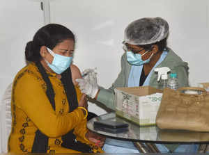 Health worker administers a dose of COVID-19 vaccine