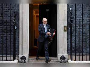 British Health Secretary Sajid Javid walks outside Downing Street in London