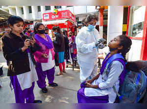 Bengaluru: A health worker conducts COVID-19 testing of commuters as 'Omicron' c...