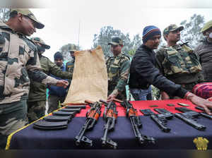 Samba: Border Security Force (BSF) personnel display the consignment of arms rec...