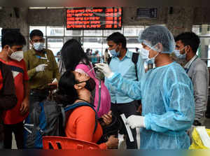 Mumbai: A healthcare worker collects a swab sample of a passenger for Covid-19 t...