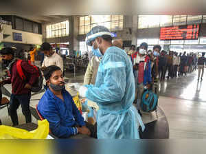 Mumbai: A healthcare worker collects a swab sample of a passenger for Covid-19 t...
