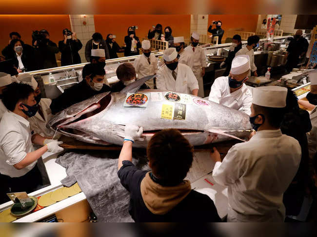 A 211-kilogram bluefin tuna that was auctioned for about 16.9 million Japanese yen or around 145,290 dollars is carried into a sushi restaurant after the first tuna auction of the New Year in Tokyo