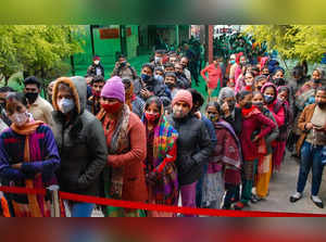 Noida: Beneficiaries stand in queues to receive COVID-19 vaccine dose, at distri...