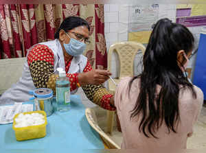 New Delhi: A health worker administers a dose of COVID-19 vaccine to a beneficia...