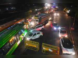 New Delhi: Police personnel check vehicles during night curfew imposed in the wa...