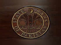 FILE PHOTO_ A logo of the State Bank of Pakistan (SBP) is pictured on a reception desk at the head office in Karachi