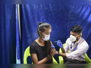 Mumbai: A health worker administers a dose of COVID-19 vaccine to a teenager, in...