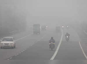New Delhi, Jan 13 (ANI): Commuters travel amid dense fog on a cold winter mornin...