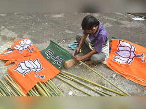 Kolkata: A worker prepares a BJP flag ahead of the Kolkata Municipal Corporation...