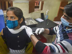 Kolkata: A Municipal Corporation worker administers a dose of COVID-19 vaccine t...