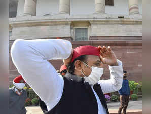 New Delhi: Samajwadi Party President Akhilesh Yadav adjusts his cap as he walk t...