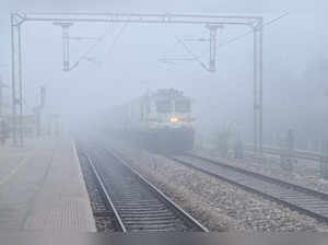 Mathura: A train runs on a railway track on a cold and foggy morning in Mathura....