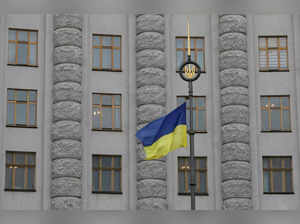 FILE PHOTO: A Ukrainian national flag flies in front of government building in central Kiev