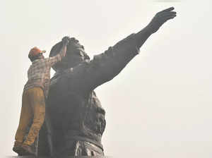 Kolkata: Workers paint a statue of Netaji Subhash Chandra Bose ahead of his birt...